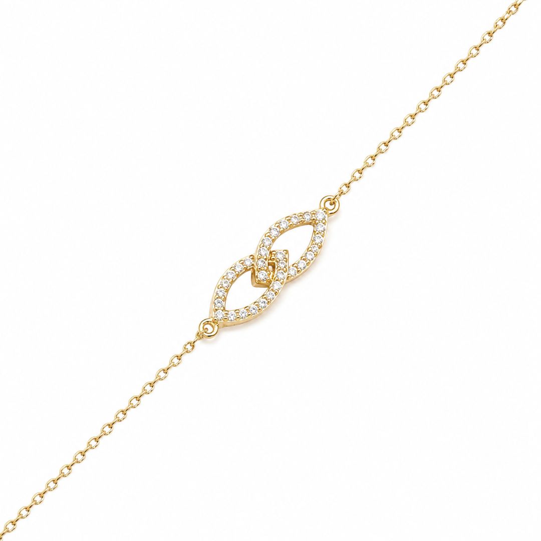 Pulsera de oro amarillo en forma junto infinito con circonitas